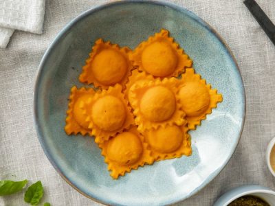 pureed carrot lentil ravioli in a pasta bowl