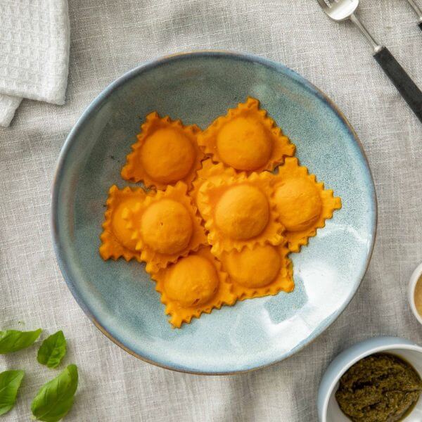 pureed carrot lentil ravioli in a pasta bowl