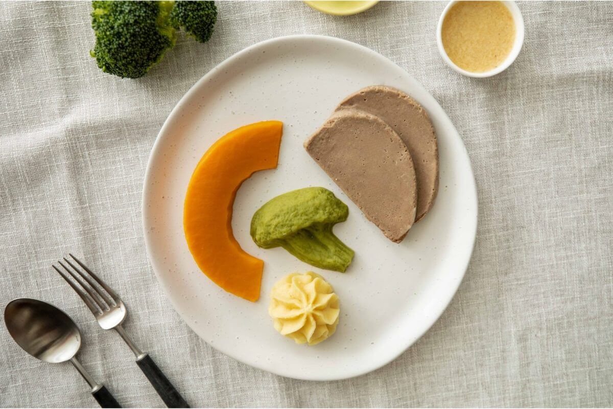 Texture modified roast lamb and vegetables on a plate