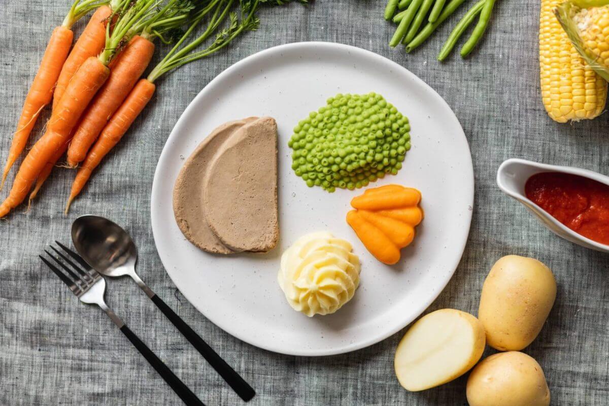 Texture modified roast beef and vegetables on a plate