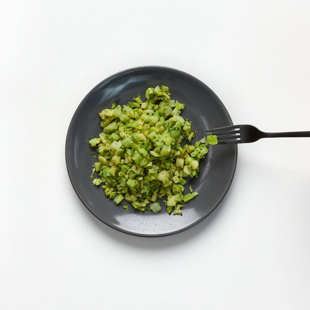 soft and bite-sized broccoli on a plate with fork
