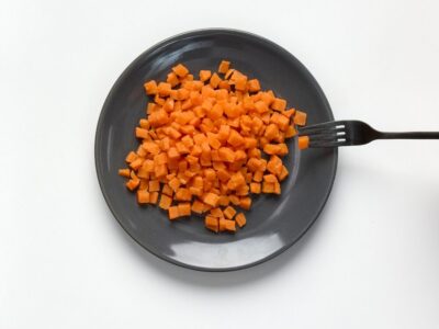 Soft and bite-sized carrot on a plate with fork
