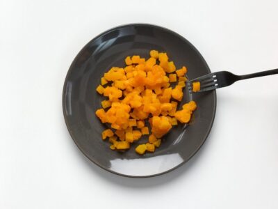 Soft and bite-sized pumpkin on a plate with fork