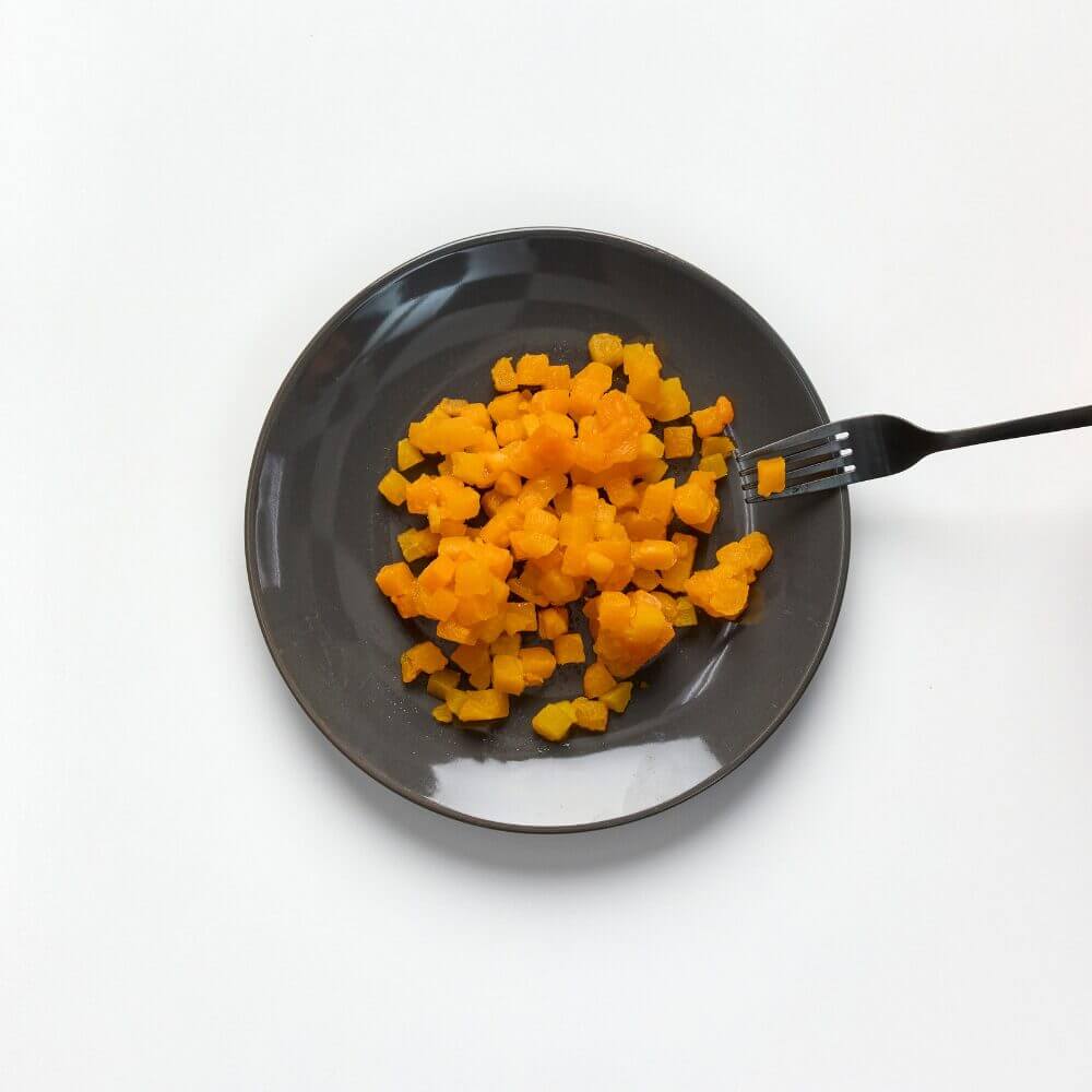 Soft and bite-sized pumpkin on a plate with fork