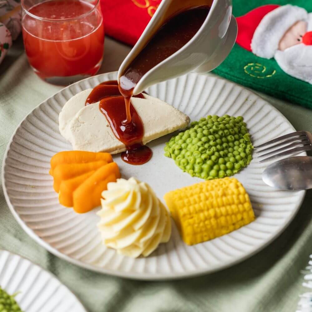 roast turkey meal with vegetables and traditional gravy on a plate